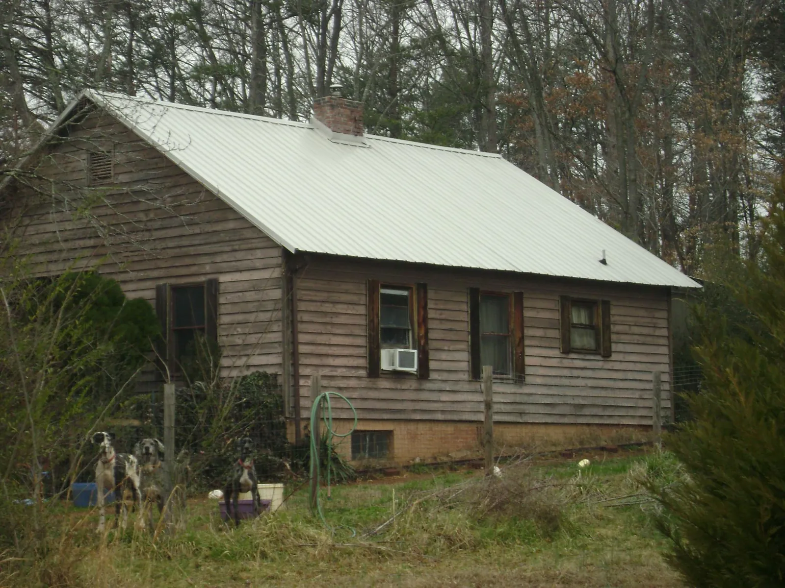 White metal roof on an old wood sided farmhouse, from a Metal Roof Installation job in Philippi